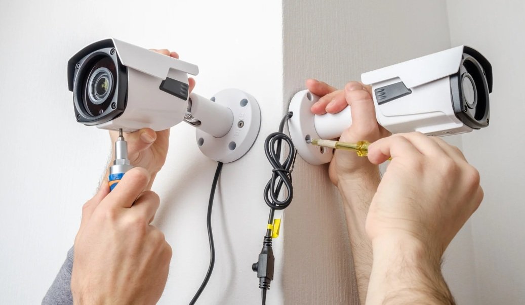 Technician installing CCTV camera